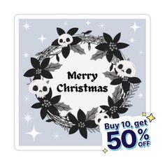 a christmas wreath with skulls and flowers on it, next to a 50 % off sale sign