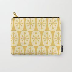 a yellow and white pattern carry - all pouch with zipper closures on the front