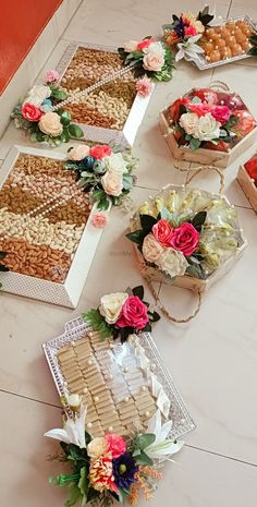 several boxes filled with different types of food on top of a white table next to each other