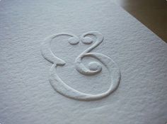 the letter g is inscribed in white paper