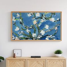 a painting hanging on the wall above a dresser