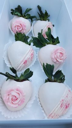 four white chocolate covered strawberries with pink roses