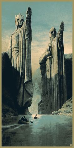 two large statues standing next to each other in front of a body of water and mountains