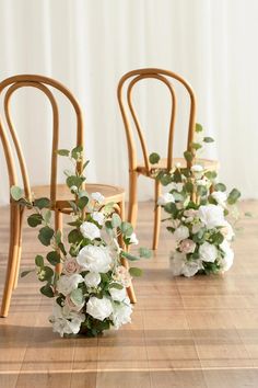 the chairs are decorated with flowers and greenery