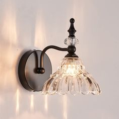 a wall light with a glass shade on it