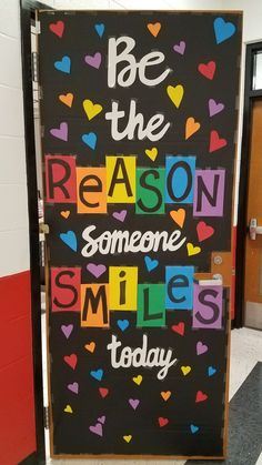 a classroom door decorated with the words be the reason someone smiles today and hearts on it