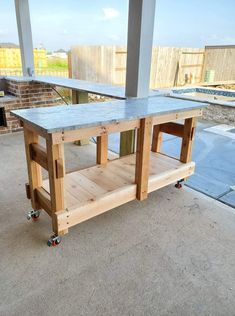 a kitchen island made out of pallet wood with wheels on the bottom and top