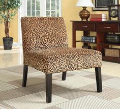 a leopard print chair sitting on top of a carpeted floor next to a table