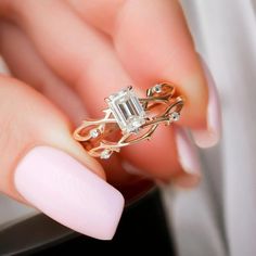 a woman's hand holding a diamond ring