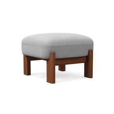 the foot stool is made out of wood and has a grey fabric cushion on it