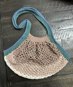 a crocheted purse sitting on top of a wooden floor