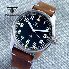 Tandorio 39mm Pilot Men's Watch Tandorio NH35A PT5000 39mm 200m Automatic Dive Pilot Men's Watch Product Description: Elevate your style with the Tandorio NH35A PT5000, a 39mm automatic dive pilot watch. Crafted with a 316L stainless steel brushed case, black dial featuring Arabic numerals with green luminous accents, and AR sapphire crystal glass, this timepiece exudes sophistication. The leather strap with pin buckle adds a touch of class. With a water resistance of 200m and a screw-down crown Automatic Watch Winder, Laptop Backpack Mens, Briefcase Women, Magnetic Jewelry, Pilot Watch, Smartphone Accessories, Wearable Device, 200m, Mens Pendant