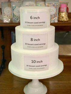 three tiered cake sitting on top of a wooden table