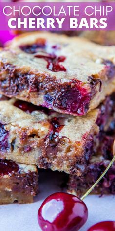 chocolate chip cherry bars stacked on top of each other with cherries in the background