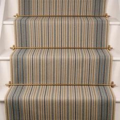 the stairs are painted with blue and yellow striped carpet