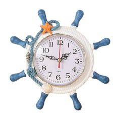 a white clock with blue ropes and stars on it's face, against a white background