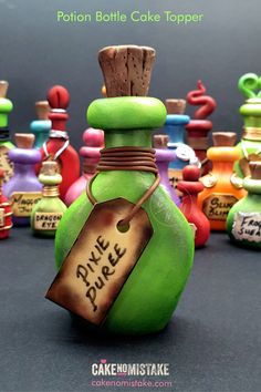 a green bottle with a tag on it sitting in front of many other colorful bottles