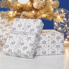 two wrapped presents sitting under a christmas tree