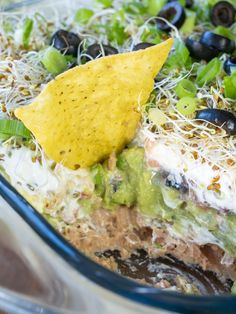 a close up of a plate of food with chips and guacamole on it