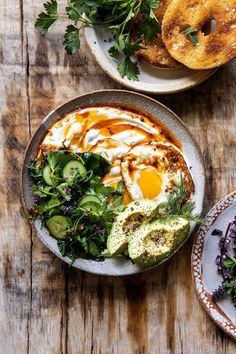 two plates filled with food on top of a wooden table