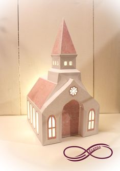 a paper model of a church on a table