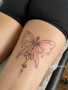 a woman's thigh with a tattoo on it