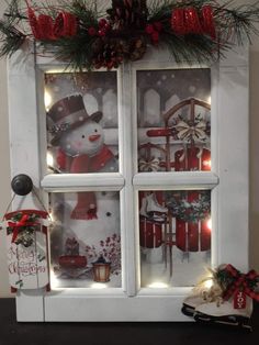 an old window decorated with christmas decorations and lights