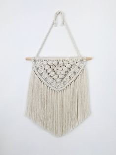 a macrame hanging on a white wall