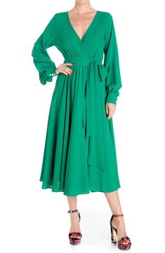 Long blousy sleeves further the elegance of a stem-baring midi fashioned with a waist tie for definition. 50" length Surplice V-neck Long sleeves Partially lined 100% polyester Hand wash, dry flat Imported Model stats: 5'10" height, 32" bust, 25" waist, 36" hip. Retro Glamour, Midi Dress Style, Fashion District, Wrap Midi Dress, Medium Dress, Mid Length Skirts, Green Midi Dress, 70s Inspired, Long Sleeve Midi