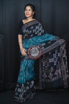 Weaver communities of Maniabandha and Nuapatana of Odisha traditionally weave this kind of saree. Common motifs are star, temple, conch, rudraksh, fish, chakra, lotus etc. The inspiration of all its designs comes from nature. It is the best of single ikat; one of warp and weft is tied and dyed prior to weaving. The borders and the pallas have tremendous variety and each one of them is attractive and praiseworthy. Specification:  Occasion: Festive Wear Fabric: Khandua Cotton Primary Color: Teal G Traditional Cotton Saree With Ikat Print, Traditional Cotton Ikat Print Saree, Black Bohemian Handloom Traditional Wear, Bohemian Black Handloom Traditional Wear, Cotton Ikat Print Saree For Festivals, Cotton Saree With Ikat Print For Festivals, Black Bohemian Saree With Woven Motifs, Bohemian Black Saree For Puja, Black Saree With Weaving For Traditional Ceremonies