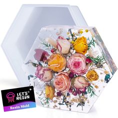 a bouquet of flowers in a clear hexagonal container