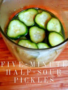 a bowl filled with sliced cucumbers on top of a wooden table