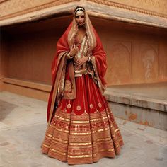 a woman in a red and gold wedding dress