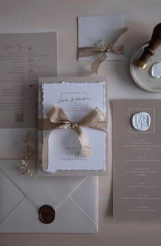 the wedding stationery is laid out on the table