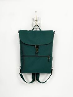 "Vegan Convertible Backpack, Women Teal Backpack, Waterproof Cross Body Bag, Minimalist Shoulder Bag, Green Functional Backpack, Laptop Bag The perfect vegan minimalist convertible backpack that balances a professional and casual look. Made from the highest waterproof of fabric and with a pleasant-touch canvas lining, this bag is guaranteed long life. Ideal for work, travel, and everything in between. Available in several sizes, just choose the right one for you. FEATURES - waterproof outer - ca Teal Backpack, Vegan Minimalist, Minimalist Shoulder Bag, Rains Backpack, Functional Backpack, Bag Minimalist, Backpack Waterproof, Backpack Laptop, Backpack Women