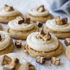 there are many cookies with white frosting on them