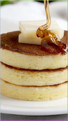 a stack of pancakes with syrup and butter on top