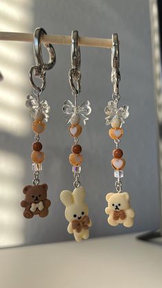 Cute beige toned/ neutral toned teddy bear or bunny key chain with bows  - the perfect accessory for your handbag, backpack, keys, or even a water bottle (this fits on the Owala water bottle)  The charm is held together by jewelry wire, and a silver heart shaped clasp. This is the perfect gift or gift to self  No purse included, only comes with the keychain. The charms are single sided. teddy bear bow heart keychain, cute teddy bear keychain, cute keychain, kawaii keychain, cute keychain gifts f Owala Water Bottle, Teddy Bear Keychain, Bottle Keychain, Clasp Bag, Keychain Charm, Girly Accessories, Heart Keychain, Brown Purses, Cute Keychain