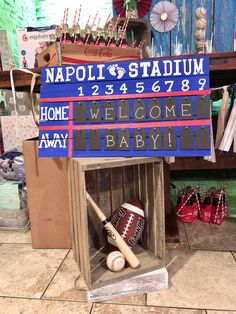 a baseball bat, glove and ball in a wooden box with a sign that says napoli stadium