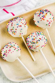 cake pops with sprinkles on a plate