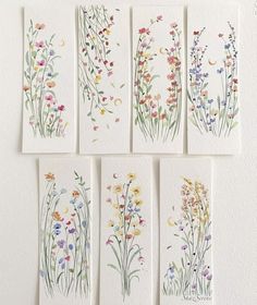 four cards with flowers painted on them in different colors and sizes, all lined up next to each other