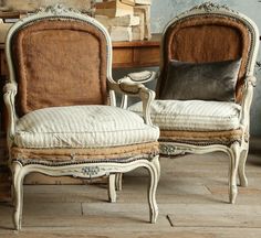 two chairs sitting next to each other on top of a wooden floor