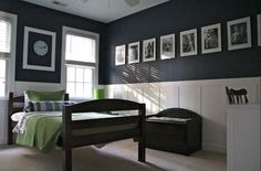 a bed room with a neatly made bed and pictures on the wall