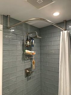 a bathroom with gray tiles and a shower head