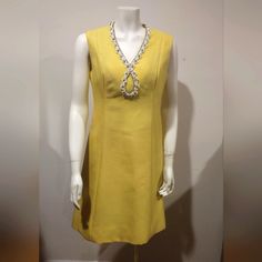 Vintage Mardi Gras Ny 1960s Lemon Yellow Beaded Cocktail Shift Dress Size 12. Mardi Gras By Levino Verna Vintage 60s Mod Lemon Yellow Shift Dress, With Gorgeous Floral Beaded And Rhinestone Trim Around Keyhole Style Neckline. Sleeveless Knee Length -Zipper Back. No Materials Label This Fabric Is Thick & Excellent Quality, Condition: Good Vintage *No Stains, Holes, Or Obvious Flaws Size, Tag Says 12 Measures Bust: 18" Flat Pit To Pit, Length: 37" Waist: 16" Groovy Hippie Twiggy Mad Men Dress Mardi Gras Dress, Mad Men Dresses, 60s Mod, Rhinestone Trim, Size 12 Dress, Lemon Yellow, Mad Men, Vintage 60s, Mardi Gras