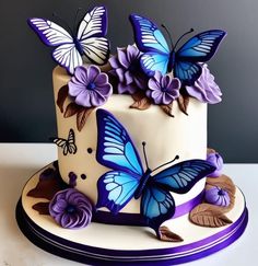 a cake decorated with butterflies and purple flowers