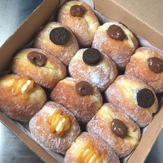 a box filled with lots of donuts covered in frosting