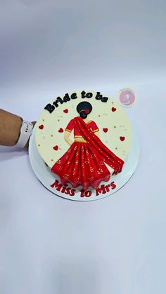 a cake that has been decorated to look like a woman in a red sari