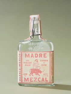 an old bottle with a label on it that says madre mezcali