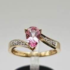 Vintage 14k Yellow Gold Pear Cut Coated Pink Topaz and Diamond Ring  Size 6.75 Item w#495 Clean and in good condition  0.89ct pink topaz (Treated and Coated to enhance the color) 0.03 carat total weight natural diamonds 3 grams Ring can be sized by your local jeweler Welcome to Westgate Jewels!! We specialize in vintage estate, designer, and fine jewelry. Our shop consists of items that are estate, antique, and / or vintage conditions unless otherwise noted. This means that most items are prior Pear Shaped Pink Ring For Formal Occasions, Pink Pear-shaped Ring For Formal Occasions, Pink Pear-shaped Formal Rings, Formal Pink Pear-shaped Rings, Fine Jewelry Pear-shaped Topaz Ring With Brilliant Cut, Pear-shaped Brilliant Cut Topaz Ring In Fine Jewelry Style, Fine Jewelry Pear-shaped Topaz Ring For Anniversary, Pear-shaped Topaz Ring For Anniversary, Fine Jewelry, Pear-shaped Topaz Ring For Anniversary